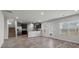 Open-concept living room with wood floors, stainless steel appliances, and abundant natural light at 3038 Chris Cir, Villa Rica, GA 30180