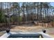 Expansive backyard featuring a beautiful pool, lush lawn, mature trees, and a privacy fence for outdoor enjoyment at 4031 Oak Forest Cir, Marietta, GA 30062