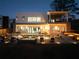 Exterior view of an illuminated outdoor living space featuring a pool, spa, and covered patio at 4031 Oak Forest Cir, Marietta, GA 30062