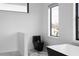 A modern bathroom featuring a black toilet, a bathtub, and natural light through sleek windows at 4031 Oak Forest Cir, Marietta, GA 30062