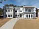 Contemporary home boasts clean lines, two stories, a balcony, and an extended concrete driveway at 4031 Oak Forest Cir, Marietta, GA 30062
