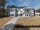 Stunning modern home featuring a contemporary design with a long driveway and landscaped front yard at 4031 Oak Forest Cir, Marietta, GA 30062