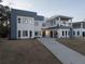 Contemporary home with a long driveway, modern architecture, dark trim, and lush landscaping at 4031 Oak Forest Cir, Marietta, GA 30062