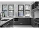 Modern kitchen with stainless steel appliances, gray cabinets, marble countertops, and abundant natural light at 4031 Oak Forest Cir, Marietta, GA 30062
