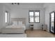 Bright main bedroom features a gray wood bedframe, wood floors and lots of natural light at 4031 Oak Forest Cir, Marietta, GA 30062