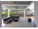 Covered patio with comfortable seating, ceiling fans, and glass railing overlooking a wooded area at 4031 Oak Forest Cir, Marietta, GA 30062