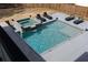 Aerial view of a stunning pool with a built-in spa, lounge chairs, and stylish design, perfect for relaxation at 4031 Oak Forest Cir, Marietta, GA 30062