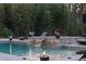 Modern pool featuring a stone hot tub with waterfall detail and cozy chaise lounges at 4031 Oak Forest Cir, Marietta, GA 30062