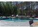 Stunning backyard pool area with a serene waterfall feature and comfortable lounge seating surrounded by lush greenery at 4031 Oak Forest Cir, Marietta, GA 30062