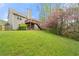 Spacious backyard with lush green lawn and a wooden deck at 1160 Chateau Ter, Mcdonough, GA 30253