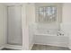 Bathroom featuring a shower and separate soaking tub at 1160 Chateau Ter, Mcdonough, GA 30253