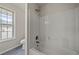Tiled bathroom with shower/tub combo and window view at 1160 Chateau Ter, Mcdonough, GA 30253