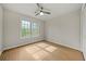 Bedroom with laminate floors, ceiling fan, natural light from the large window, and closet at 1160 Chateau Ter, Mcdonough, GA 30253