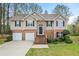 Charming two-story home with brick accents, a two-car garage, and manicured landscaping at 1160 Chateau Ter, Mcdonough, GA 30253