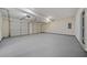 Spacious three car garage with painted walls, multiple doors, and overhead lighting at 1160 Chateau Ter, Mcdonough, GA 30253