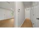 Hallway with a coat closet leading to an open-concept living space, featuring laminate floors at 1160 Chateau Ter, Mcdonough, GA 30253