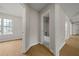 Hallway with bathroom and bedroom doorways, wood floors at 1160 Chateau Ter, Mcdonough, GA 30253