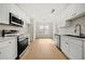 Bright kitchen features stainless steel appliances and white cabinetry at 1160 Chateau Ter, Mcdonough, GA 30253