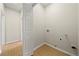 Functional laundry room with laminate floors, utility connections, and plenty of space at 1160 Chateau Ter, Mcdonough, GA 30253
