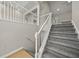 Carpeted staircase with white railings leads to the upper level at 1160 Chateau Ter, Mcdonough, GA 30253