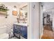 Chic bathroom boasts a blue vanity, a decorative mirror, open shelving, and stylish decor at 91 Ne Rumson Ne Rd # B20, Atlanta, GA 30305