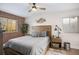 Comfortable bedroom with a wood-paneled headboard, brick accent wall, a ceiling fan, and natural light at 91 Ne Rumson Ne Rd # B20, Atlanta, GA 30305