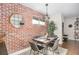 Inviting dining room area with brick accent wall, pendant lighting, seating for four, and stylish decor at 91 Ne Rumson Ne Rd # B20, Atlanta, GA 30305
