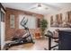 Inviting home gym with an elliptical machine, exposed brick wall, and decor at 91 Ne Rumson Ne Rd # B20, Atlanta, GA 30305