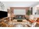Comfortable living room boasts exposed brick wall, sofa, and stylish decor at 91 Ne Rumson Ne Rd # B20, Atlanta, GA 30305