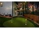 Backyard at dusk features an artificial turf putting green and ambient string lights at 2015 Chelton Se Way, Smyrna, GA 30080