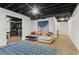 Basement living area with an exposed ceiling, walk-in closet, and a comfortable sofa at 2015 Chelton Se Way, Smyrna, GA 30080