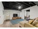 Finished basement with a lounge area, exposed ceiling, and walk-out door at 2015 Chelton Se Way, Smyrna, GA 30080