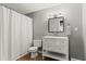 Clean bathroom featuring a white vanity, a modern framed mirror, and a shower with a white curtain at 2015 Chelton Se Way, Smyrna, GA 30080