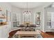 Bright breakfast nook with hardwood floors, white cabinets, a modern light fixture, and backyard views at 2015 Chelton Se Way, Smyrna, GA 30080