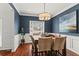 Cozy dining room boasts blue accent walls, hardwood floors, and a sunny window at 2015 Chelton Se Way, Smyrna, GA 30080