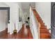Bright, two-story foyer featuring hardwood floors, white wainscoting, and an open staircase at 2015 Chelton Se Way, Smyrna, GA 30080
