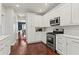 Bright kitchen featuring stainless steel appliances, modern countertops, and hardwood floors at 2015 Chelton Se Way, Smyrna, GA 30080