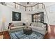 Spacious living room with two sofas, hardwood floors, and a view of the second-story balcony at 2015 Chelton Se Way, Smyrna, GA 30080