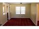 Cozy living room with plush red carpet, classic trim, and natural light at 130 Scarlet Dr, Jonesboro, GA 30236