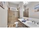 Bathroom with a double sink vanity, neutral countertops, and tiled walk-in shower with glass door at 244 Cedar Ridge Way, Dallas, GA 30157