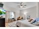 Bright bedroom with ceiling fan, hardwood floors, desk, and cozy furniture at 244 Cedar Ridge Way, Dallas, GA 30157
