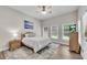 Bright bedroom with windows, hardwood floors, ceiling fan, rug, and a comfortable bed at 244 Cedar Ridge Way, Dallas, GA 30157