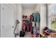 Walk-in closet with built-in shelving, rods, neutral colors and many windows at 244 Cedar Ridge Way, Dallas, GA 30157