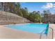 Community pool with clear blue water and surrounding sun deck, perfect for summer enjoyment at 244 Cedar Ridge Way, Dallas, GA 30157