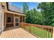 Spacious wooden deck with a view of the fenced backyard and mature trees at 244 Cedar Ridge Way, Dallas, GA 30157
