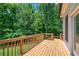Spacious wooden deck with a view of the fenced backyard and mature trees at 244 Cedar Ridge Way, Dallas, GA 30157