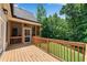 Spacious wooden deck with a view of the fenced backyard and mature trees at 244 Cedar Ridge Way, Dallas, GA 30157