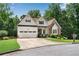 Inviting home with stone and white siding, an attached garage, and beautiful landscaping with a well-maintained lawn at 244 Cedar Ridge Way, Dallas, GA 30157