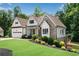 Beautiful stone and siding home with an attached garage, manicured lawn, and professional landscaping for great curb appeal at 244 Cedar Ridge Way, Dallas, GA 30157