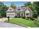 Charming home with stone and white facade and a well maintained lawn with colorful flower beds for extra curb appeal at 244 Cedar Ridge Way, Dallas, GA 30157